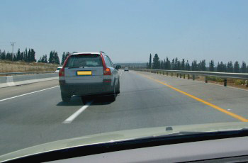 What are you required to do when you see that the overtaking silver vehicle intends to return to the right lane?